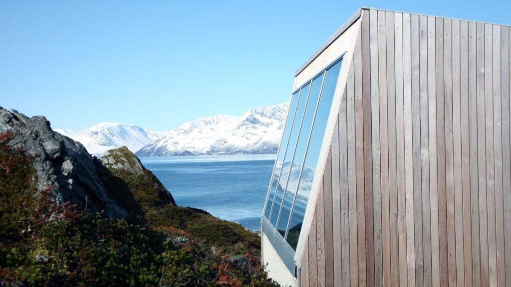 Panoramic windows on three sides of the wooden house