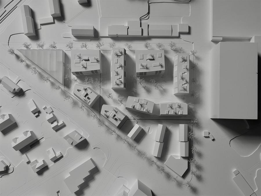 Geschickt gestaffelt: Die Positionierung der Neubauten dient dem Lärmschutz und verschafft dem „Quartier der tanzenden Paare" geborgene Freiflächen. (Bild: KCAP)